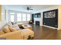 Spacious living room with a fireplace, plush sectional sofa, and large windows with bright natural light at 2282 Mclean Chase Se, Smyrna, GA 30080