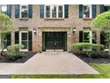 Close-up of double front doors with stone detail and manicured landscaping at 335 Cedar Ln, Fayetteville, GA 30214