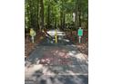 View of golf cart path with signage through a wooded community at 335 Cedar Ln, Fayetteville, GA 30214