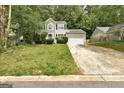 Charming two-story home with stone accents and a two-car garage nestled amongst mature trees at 1960 Morning Nw Walk, Acworth, GA 30102