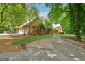 Lovely home featuring a two-car garage and mature trees, offering a peaceful and private setting at 9255 Betony Wood Trl, Jonesboro, GA 30236