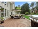 Relaxing back deck with outdoor seating, umbrella, and a grill, perfect for entertaining and enjoying the backyard view at 1029 Ector Nw Dr, Kennesaw, GA 30152