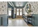 Elegant foyer with hardwood floors, decorative wallpaper, and stylish console table at 415 Discovery Lake Dr, Fayetteville, GA 30215
