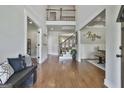 Two-story foyer with hardwood floors, iron railing staircase, and open views to other living spaces at 101 Sumner Place Ct, Peachtree City, GA 30269