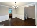 Elegant dining room with chair rail detail, chandelier lighting and hardwood flooring, adding sophistication at 3814 Clear Lake Nw Way, Acworth, GA 30101