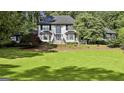 Charming two-story home with a well-manicured lawn, brick exterior, and lots of shade trees at 209 Smokerise Trce, Peachtree City, GA 30269