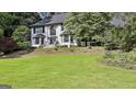 Charming two-story home with a well-manicured lawn, brick exterior, and mature tree coverage at 209 Smokerise Trce, Peachtree City, GA 30269