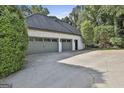 Spacious three-car garage with gray doors and a driveway with plenty of parking at 209 Smokerise Trce, Peachtree City, GA 30269