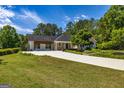 Well-maintained home with extended driveway and an attached pergola-covered outdoor space at 255 Mcintosh Estates Dr, Sharpsburg, GA 30277