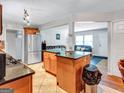 Open-concept kitchen with granite countertops, stainless steel appliances, and access to both the living and dining spaces at 3059 Will Rogers Se Pl, Atlanta, GA 30316