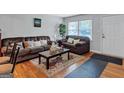 Inviting living room featuring hardwood floors, comfortable seating, and soft natural light from nearby windows at 3059 Will Rogers Se Pl, Atlanta, GA 30316