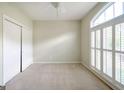Bright bedroom featuring shuttered windows, ceiling fan, and closet space at 335 Grand Teton Cir, Fayetteville, GA 30215