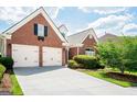 Attractive brick home featuring an attached two-car garage and well-kept landscaping at 335 Grand Teton Cir, Fayetteville, GA 30215