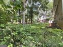 Backyard with privacy fence surrounded by mature shade trees at 4116 Warrior Trl, Stone Mountain, GA 30083