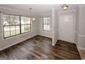 Bright dining room featuring new floors, large windows, and modern lighting at 5461 Park S Pl, Atlanta, GA 30349