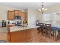 Well-equipped kitchen with an island, stainless appliances, and an adjacent dining area at 138 Brookhaven Dr, Villa Rica, GA 30180