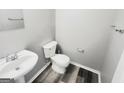 Cozy half-bathroom featuring a toilet, sink, and modern fixtures for a functional and stylish space at 1464 Riverrock Trl, Riverdale, GA 30296