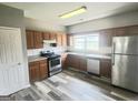 Bright kitchen with stainless steel appliances, ample cabinetry, and stylish flooring for a modern appeal at 1464 Riverrock Trl, Riverdale, GA 30296
