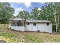 Back of a charming white brick house with a screened in porch at 126 Country Acres Ct, Mcdonough, GA 30253