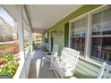 Inviting covered front porch with rocking chairs, perfect for relaxing outdoors at 577 Rivers Rd, Fayetteville, GA 30214