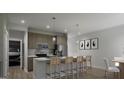 Modern kitchen boasts stainless steel appliances, an eat-in island, and bright white countertops at 2040 Piccolo Ct # 224, Mcdonough, GA 30252