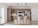 Modern kitchen with stainless steel appliances, marble backsplash, and breakfast bar seating at 1246 Trombone Way # 111, Mcdonough, GA 30252