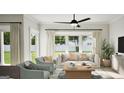 Bright living room featuring stylish armchairs, a comfortable sofa, and a large window with backyard view at 2024 Piccolo Ct # 228, Mcdonough, GA 30252