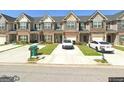 View of the townhouse complex showing each unit with garages, driveways and small lawn at 5257 Carrie Dr, Morrow, GA 30260