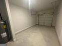 View of an attached garage with cement floor and garage door at 5257 Carrie Dr, Morrow, GA 30260