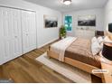 Staged bedroom with cozy decor, a large window, and ample closet space at 355 New Marietta Hwy, Roswell, GA 30075