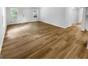 Bright and open living room with beautiful wood-style flooring and a fresh, neutral color palette at 355 New Marietta Hwy, Roswell, GA 30075