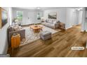Staged living room featuring modern furniture, a patterned rug and natural light at 355 New Marietta Hwy, Roswell, GA 30075