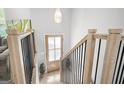 Bright entryway with wood stairs, black metal balusters, and natural wood trim at 474 Autumn Dr, Riverdale, GA 30274