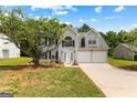 Two-story home featuring a well-manicured lawn, two-car garage, and a welcoming entrance at 4506 White Rd, Douglasville, GA 30135