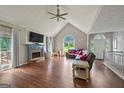 Spacious living room with a stone fireplace, hardwood floors, and plenty of natural light at 6645 N Glen Dr, Cumming, GA 30028