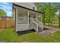 Side view of a quaint two-story home with a lovely front porch and manicured lawn at 786 Neal Nw St, Atlanta, GA 30318