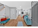 Bright, open-concept living area with hardwood floors, modern furnishings and a staircase at 786 Neal Nw St, Atlanta, GA 30318