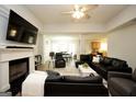 Open-concept living room with fireplace flows into the dining area and kitchen at 9067 Bob Jackson Dr, Jonesboro, GA 30238