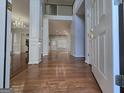 Spacious foyer with hardwood floors and elegant architectural details with views to a grand staircase at 3773 Summer Rose Dr, Atlanta, GA 30341