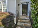 Inviting stone steps leading to the home's entrance with a black screen door at 3773 Summer Rose Dr, Atlanta, GA 30341