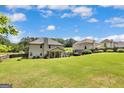 Spacious backyard with lush green grass and mature trees, perfect for outdoor activities at 465 Harris Dr, Conyers, GA 30012