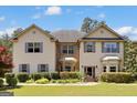 Inviting two-story home featuring a mix of neutral siding and brick, paired with blue shutters at 465 Harris Dr, Conyers, GA 30012