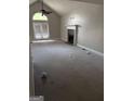 Bright living room with a vaulted ceiling, fireplace and french doors to the outside at 227 Cedars Glen Cir, Villa Rica, GA 30180