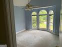 Bright bedroom with high ceilings, arched windows and scenic views at 9160 Woodhaven Way, Mcdonough, GA 30253