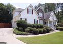 Charming two-story home with beautiful landscaping, a stone facade, and a well-manicured lawn at 74 Flanders Ct, Douglasville, GA 30134