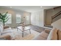 Bright living room featuring hardwood floors, modern furnishings, neutral paint, and abundant natural light at 8747 Lakeview Commons # 1, Jonesboro, GA 30238
