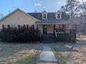 Charming single-story home featuring a welcoming front porch and well-maintained landscaping at 5700 Miles Rd, South Fulton, GA 30349