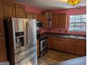 Well-equipped kitchen with stainless steel appliances and wood cabinets at 5700 Miles Rd, South Fulton, GA 30349