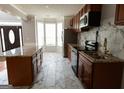 Spacious kitchen with marble countertops and backsplash, stainless steel appliances, and tile flooring at 5113 Heritage Oaks Sw Ln, Powder Springs, GA 30127