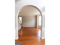 Bright living room with hardwood floors, wainscotting, and archway at 5113 Heritage Oaks Sw Ln, Powder Springs, GA 30127
